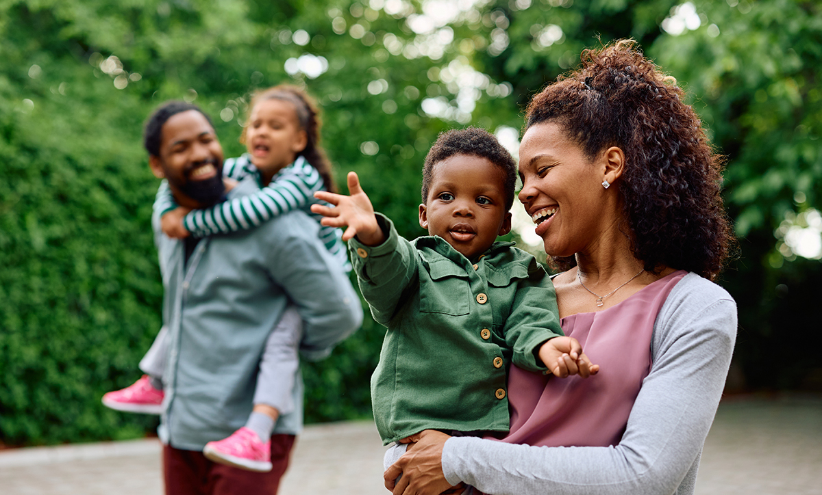 Two parents, each holding a child