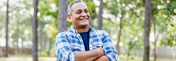 Smiling man with arms folded