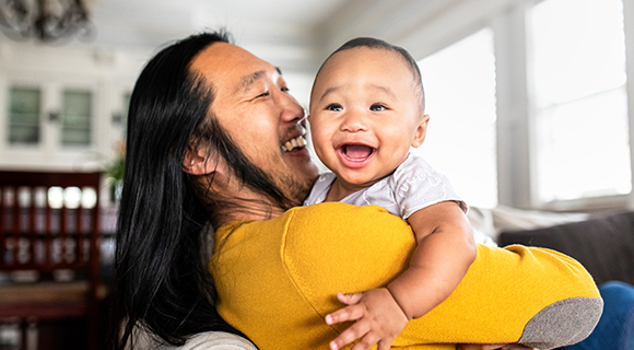 Man with very happy baby